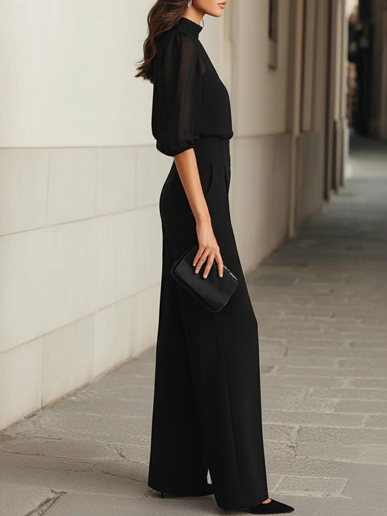 Tre-dels set i svart, bestående av transparent camisole-top och vida byxor