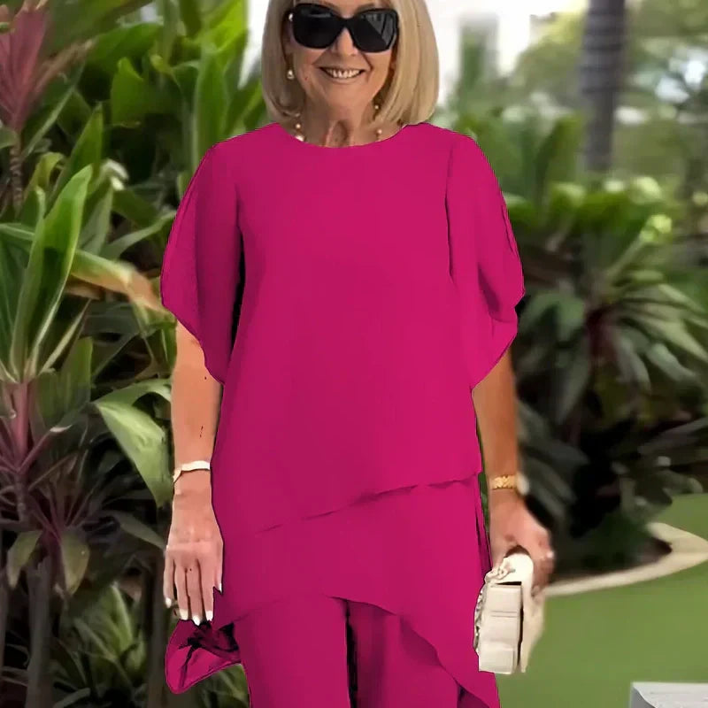 Charmigt set med oregelbunden topp Elegant set med vida byxor – Bekväma och perfekta för våren